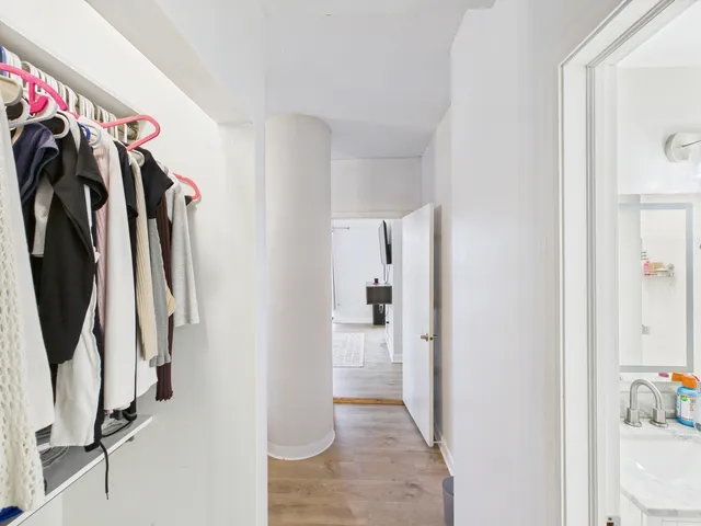 a view of walk in closet with clothes and shoes