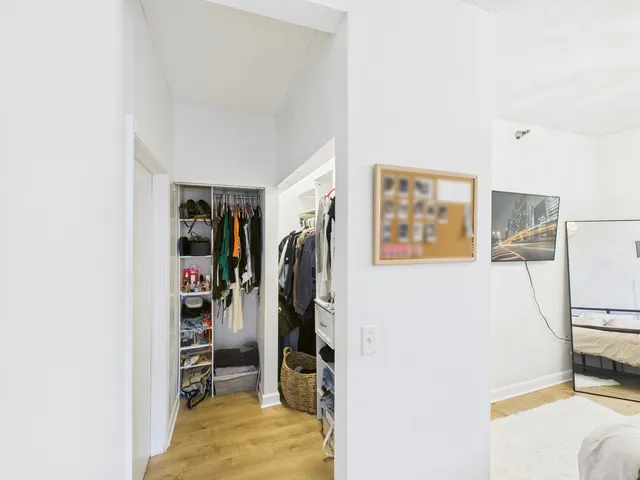 a view of a bedroom with a bed and a window