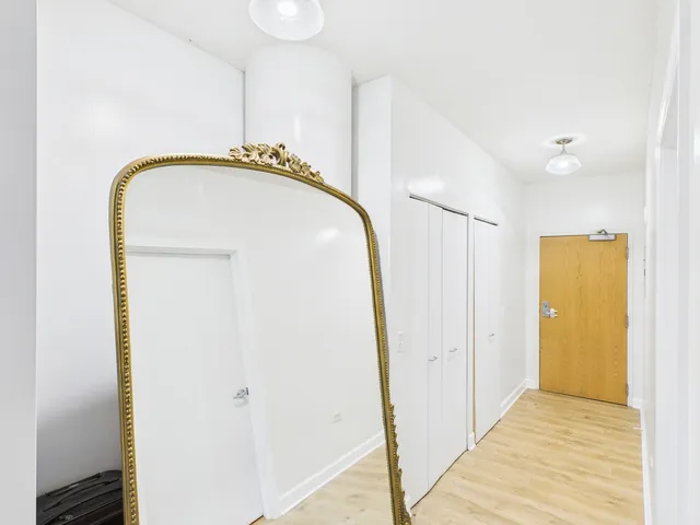 a bathroom with a sink mirror and shower