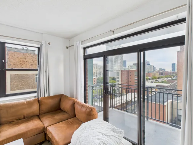 a living room with furniture and a floor to ceiling window