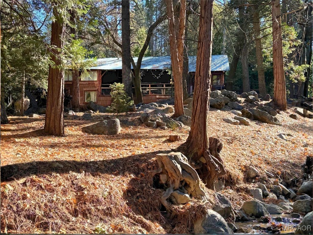 a view of a house with snow on the side of the road