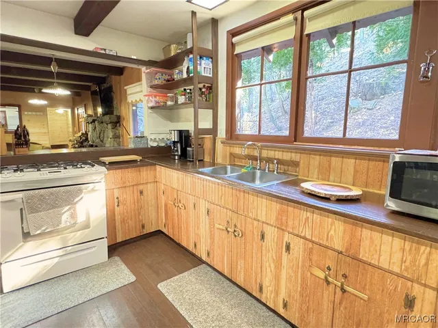 a kitchen with granite countertop a sink and white cabinets