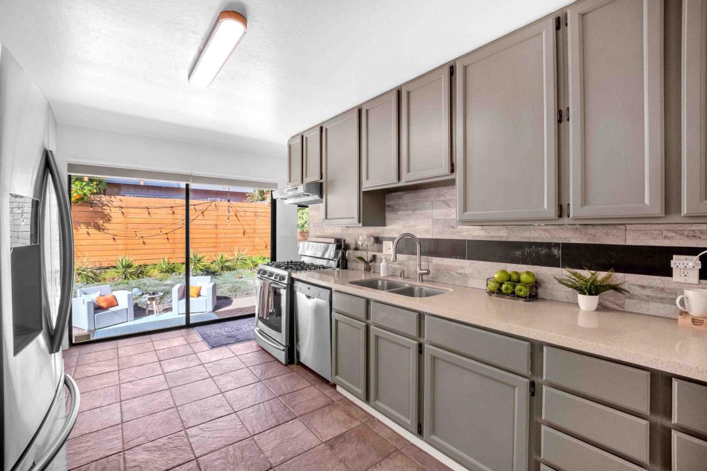 5519 Amend Road El Sobrante, CA 94803 - Photo 13 of 38 a kitchen with stainless steel appliances a sink a stove and a window