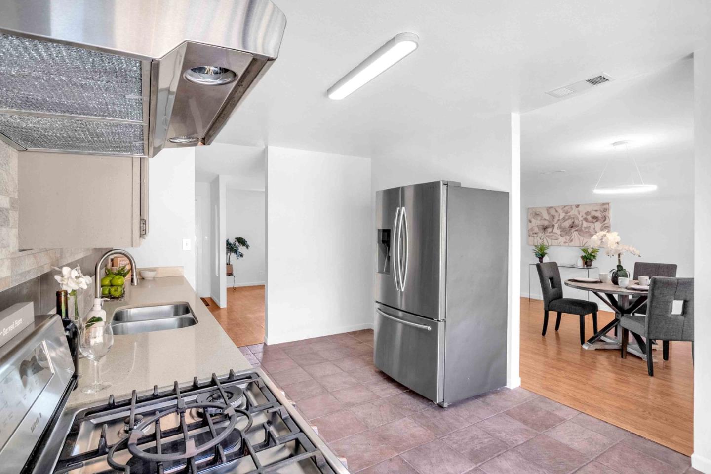 5519 Amend Road El Sobrante, CA 94803 - Photo 15 of 38 a kitchen with stainless steel appliances granite countertop a refrigerator and a sink