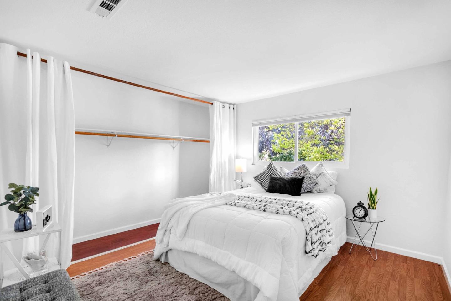 5519 Amend Road El Sobrante, CA 94803 - Photo 20 of 38 a bedroom with a bed and a potted plant