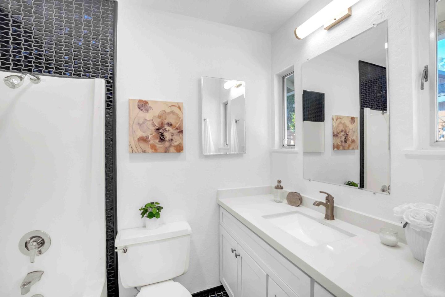 5519 Amend Road El Sobrante, CA 94803 - Photo 25 of 38 a bathroom with a sink mirror vanity and toilet