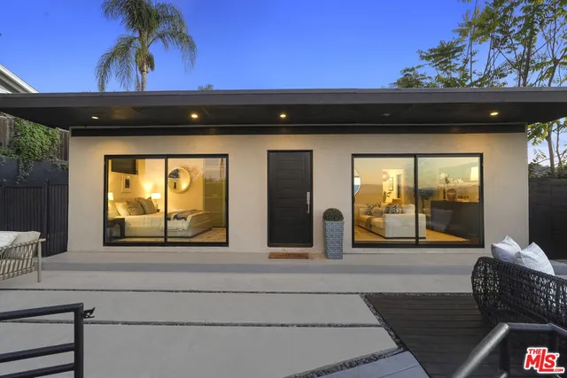 a view of a lake with couches chairs