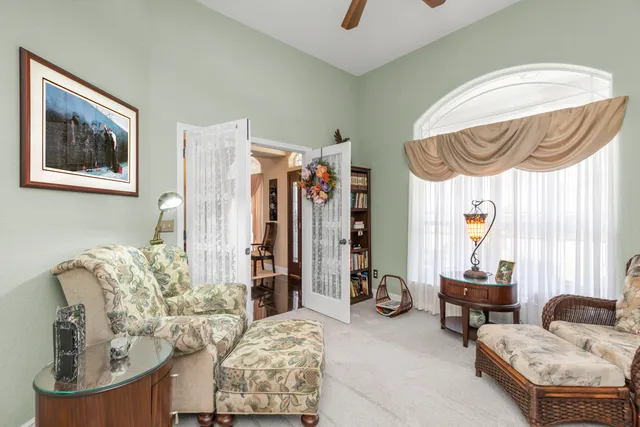a living room with furniture and a chandelier