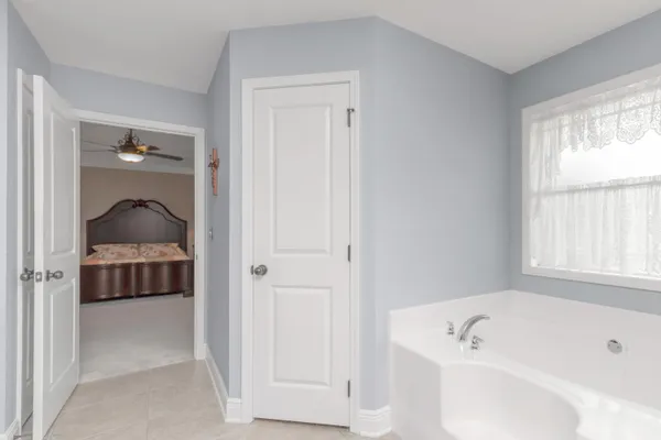 a bathroom with a tub shower and sink