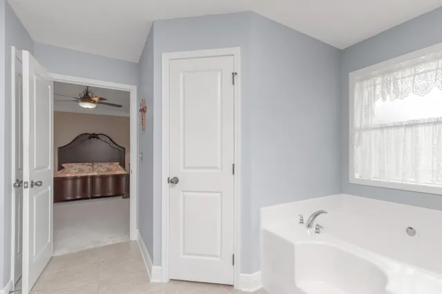 a bathroom with a tub shower and sink