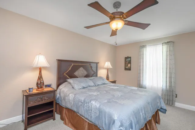 a bedroom with a bed and a lamp