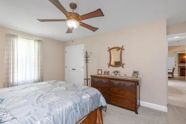 a bedroom with a bed and a dresser in it