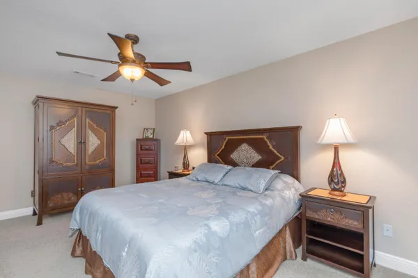 a bedroom with a bed and a lamp on table