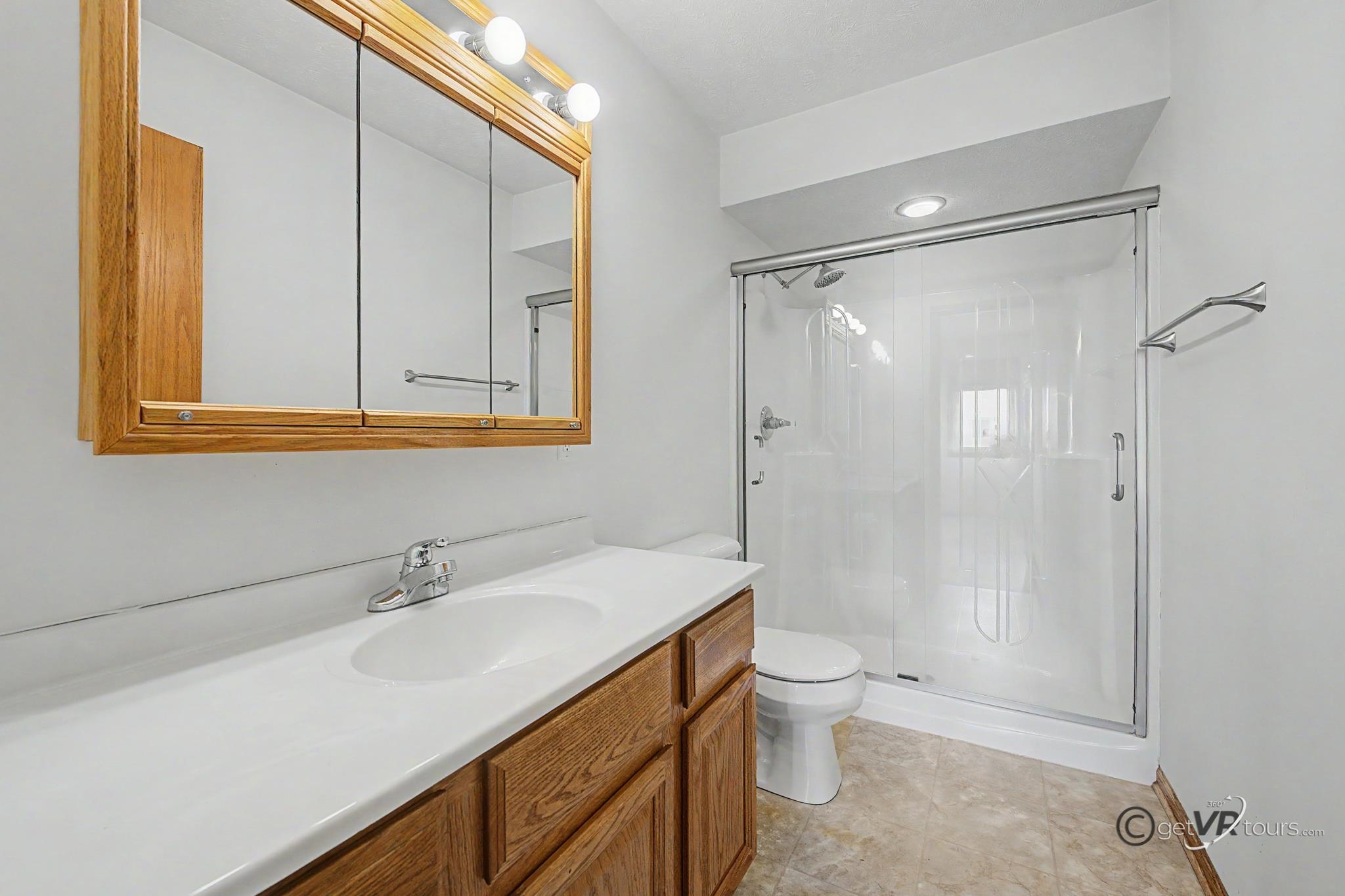 3127 Sandy Pointe Drive Freeport, IL 61032 - Photo 12 of 35 a bathroom with a sink toilet double vanity and shower