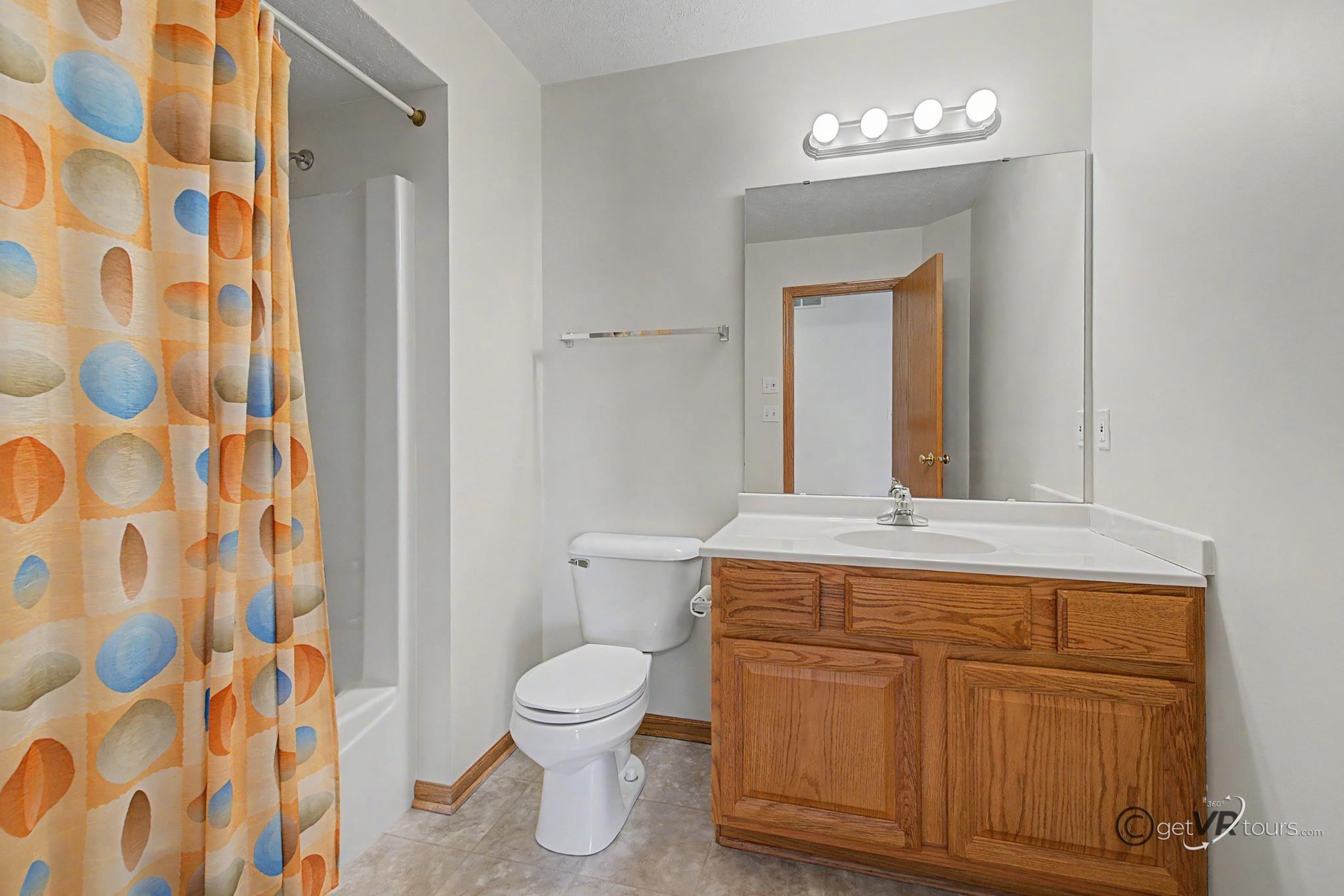 3127 Sandy Pointe Drive Freeport, IL 61032 - Photo 15 of 35 a bathroom with a toilet a sink and a mirror
