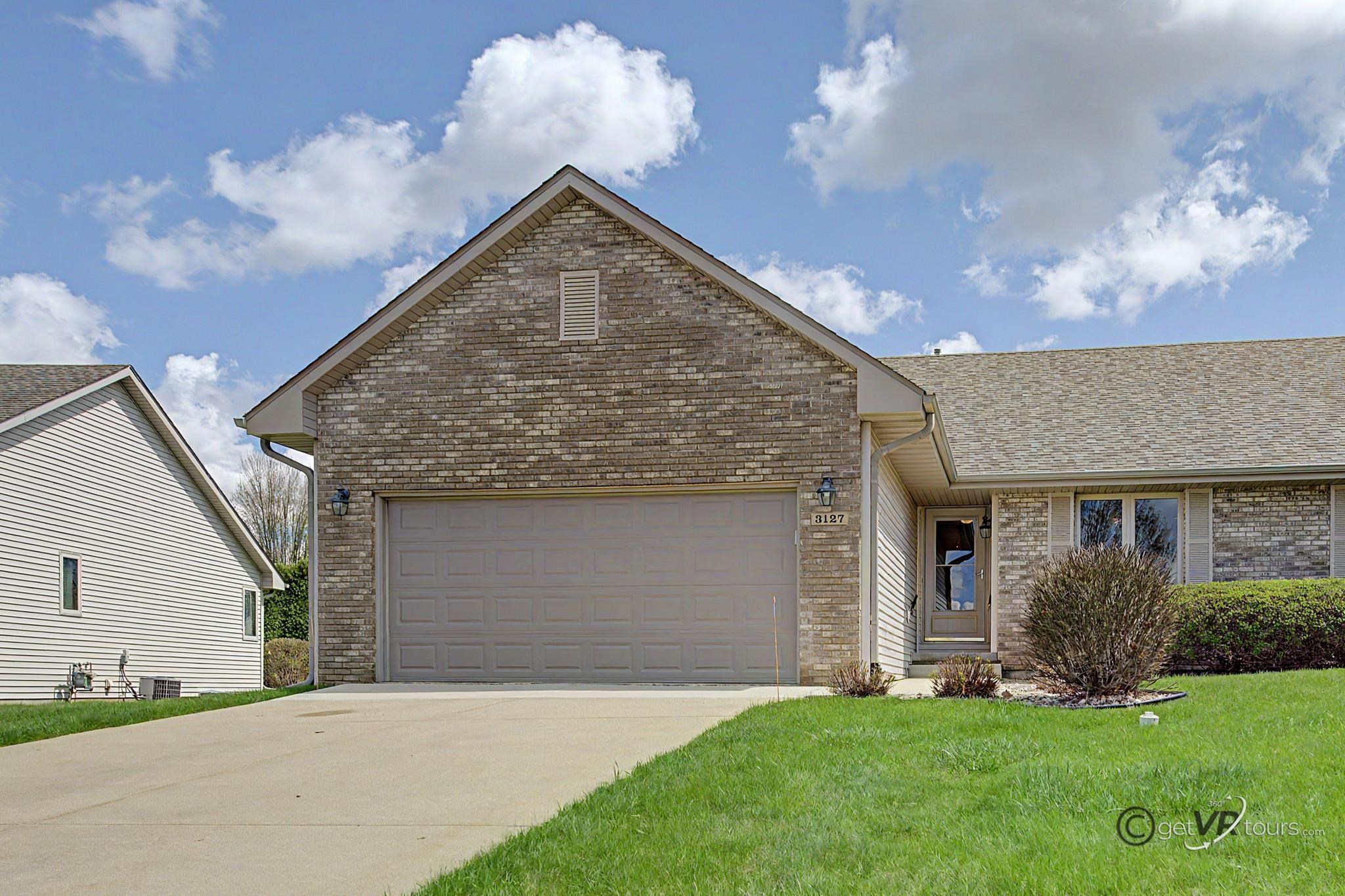 3127 Sandy Pointe Drive Freeport, IL 61032 - Photo 28 of 35 a front view of a house with a yard and garage