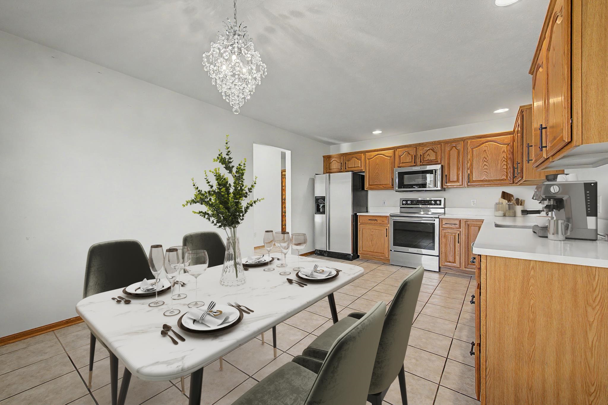 3127 Sandy Pointe Drive Freeport, IL 61032 - Photo 6 of 35 a view of a dining room with furniture a kitchen and chandelier