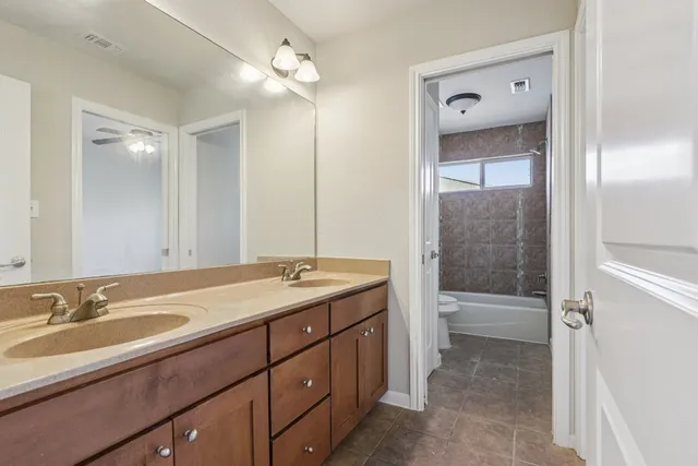 a bathroom with a sink double vanity granite tub and shower