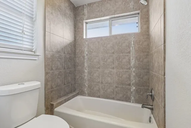 a bathroom with a bathtub and a toilet
