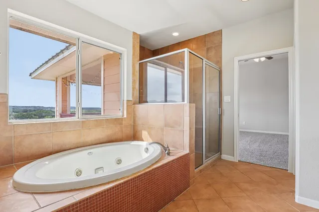 a bathroom with a tub and shower