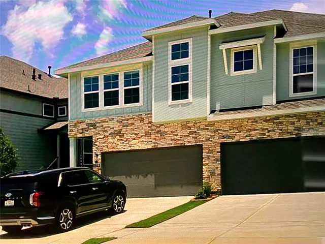 a view of a house with a car park side of road