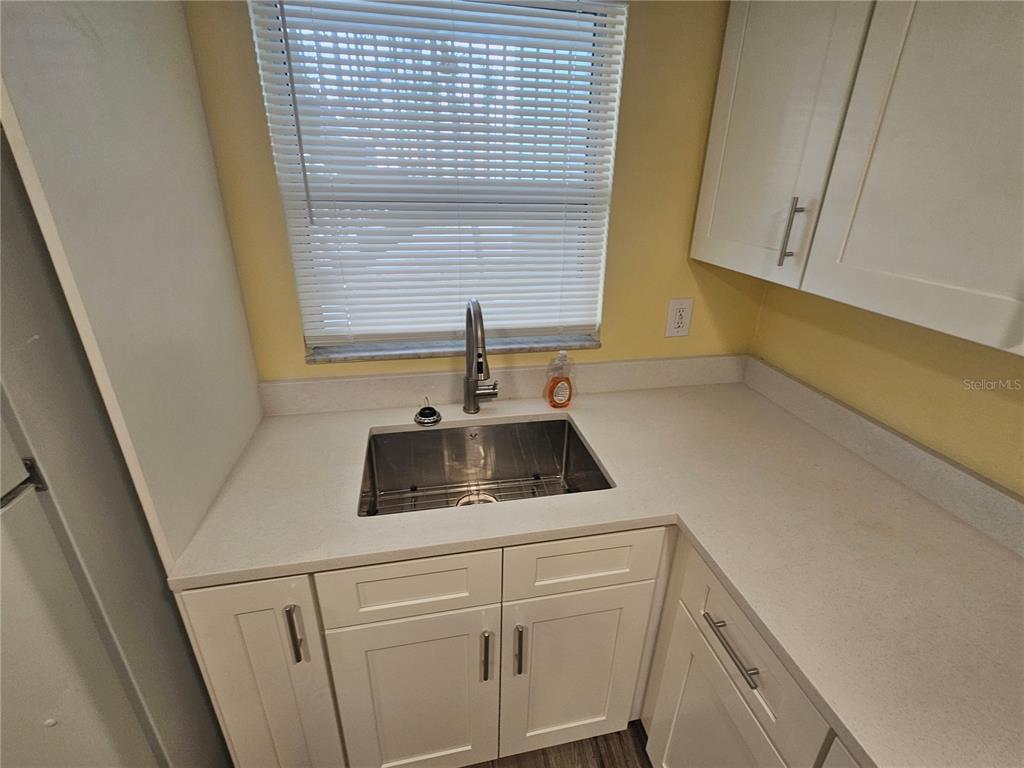 2045 Alpine Road, Unit 3 Clearwater, FL 33755 - Photo 9 of 18 a kitchen with a sink and cabinets