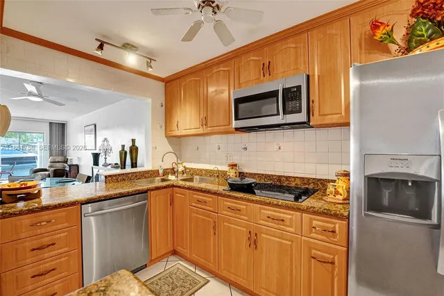 a kitchen with stainless steel appliances a stove sink microwave and cabinets
