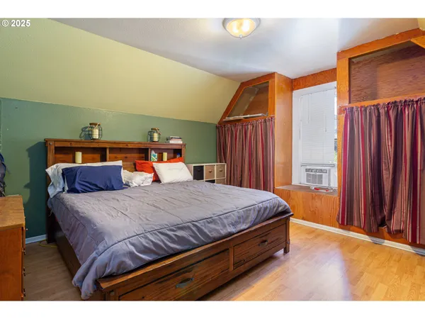 a bed sitting in a bedroom next to a window