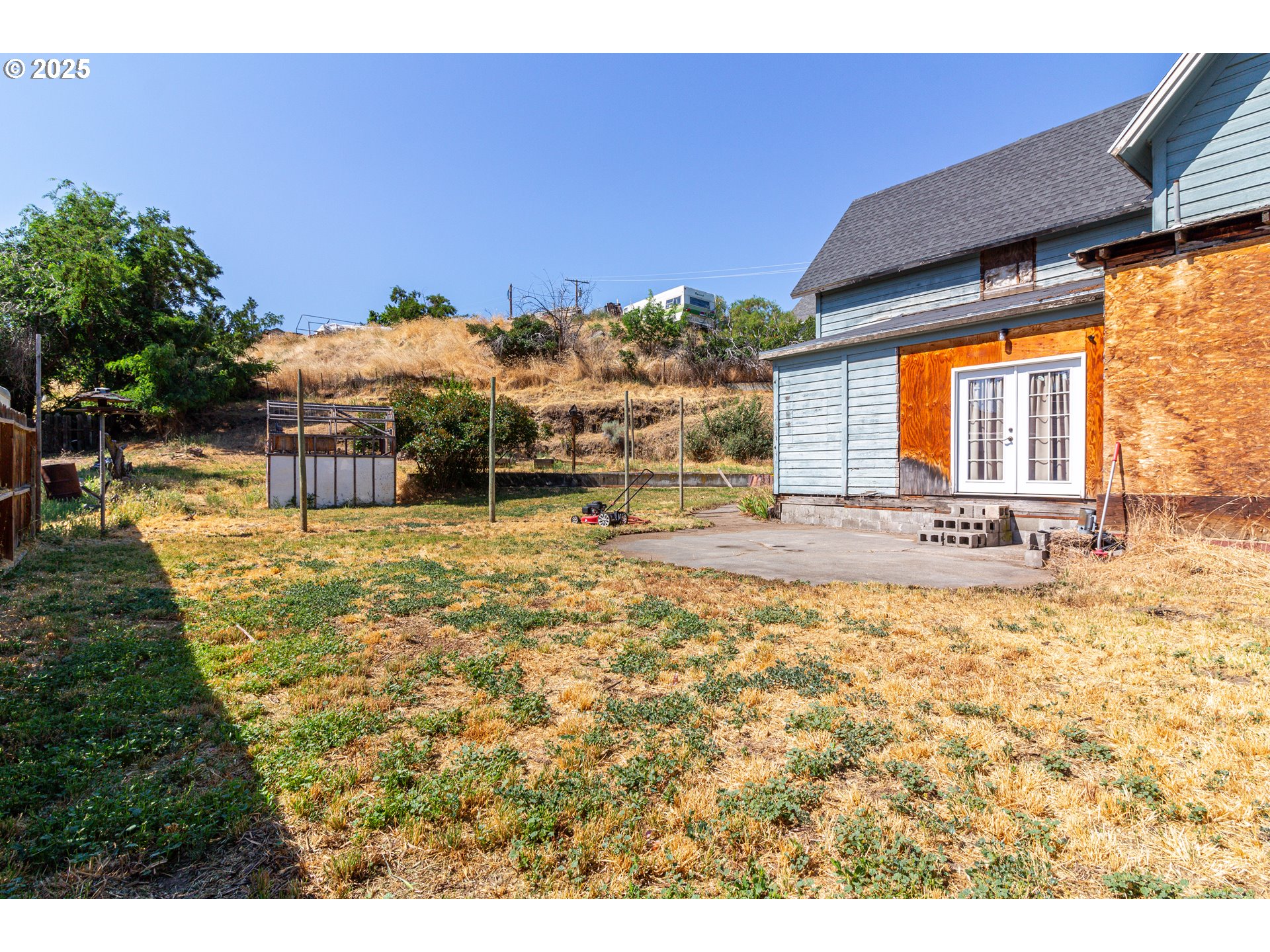 220 Cannon Street Heppner, OR 97836 - Photo 15 of 25 a swimming pool with outdoor seating and yard