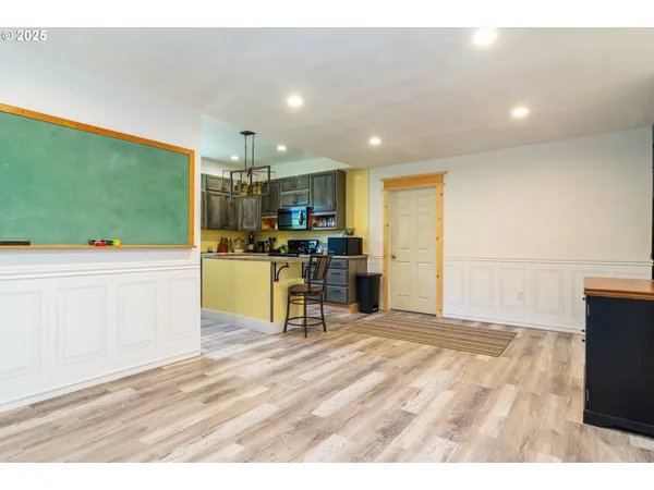 a kitchen with stainless steel appliances kitchen island granite countertop a refrigerator and a stove top oven