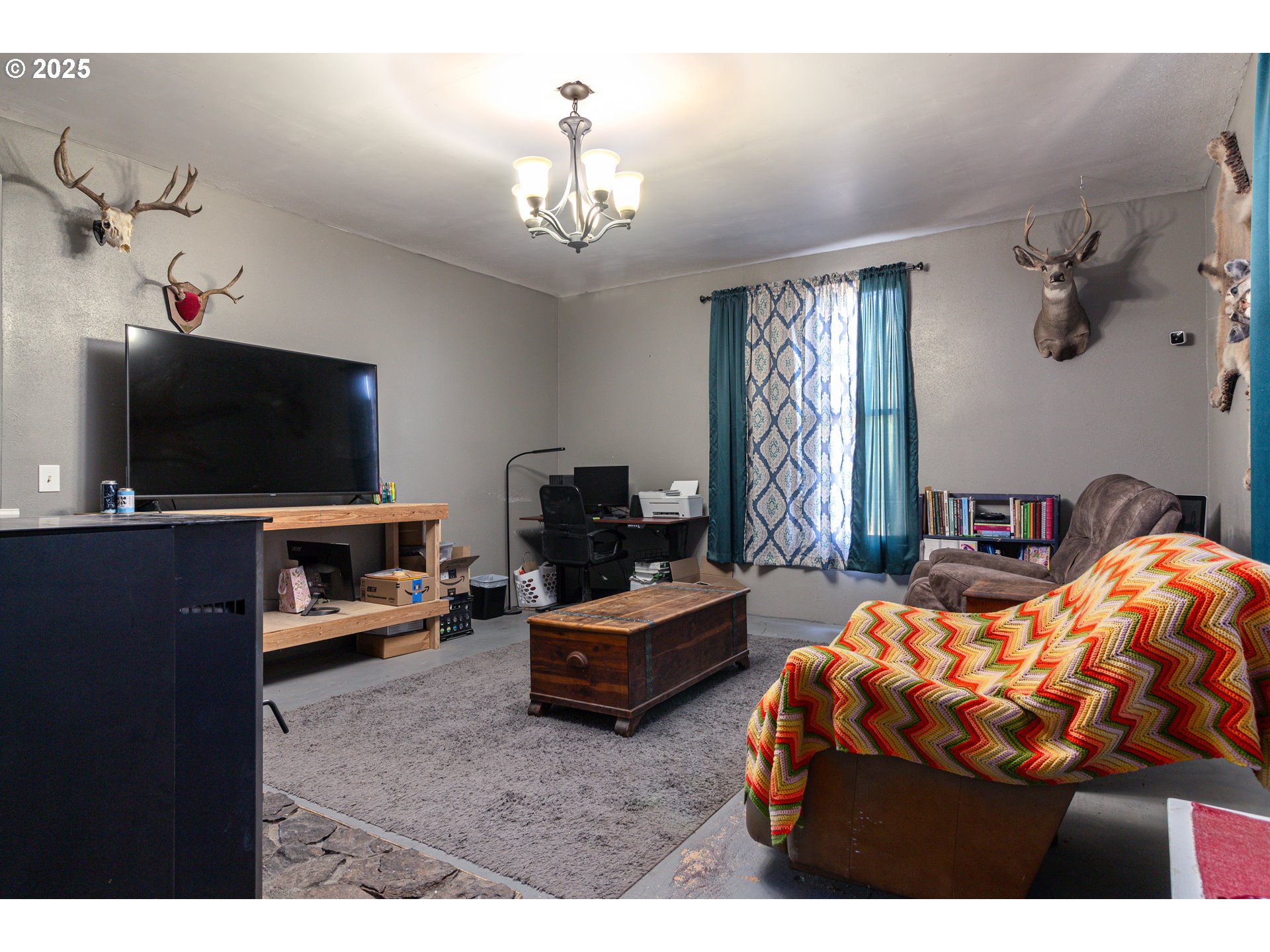 220 Cannon Street Heppner, OR 97836 - Photo 2 of 25 a bedroom with furniture and a flat screen tv