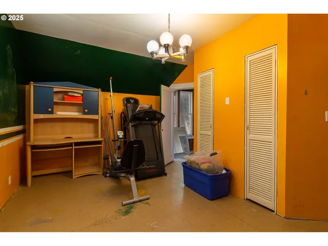 a room with gym equipment and a flat screen tv