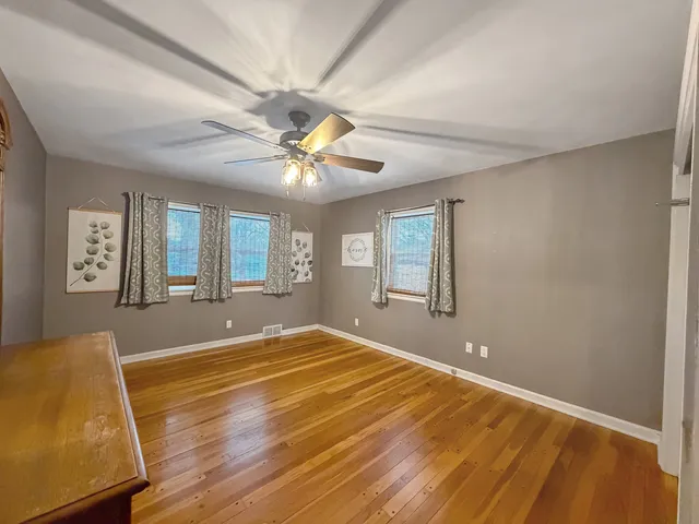 a view of a livingroom with a furniture and chandelier fan