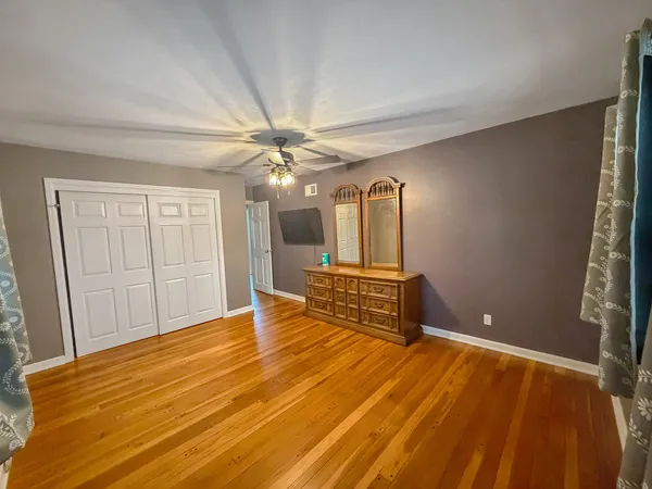 a spacious bedroom with a bed and a chandelier