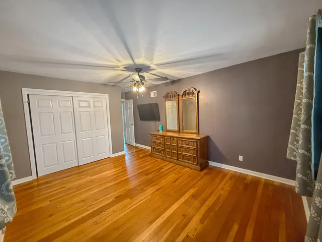 a spacious bedroom with a bed and a chandelier