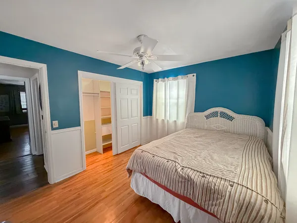 a spacious bedroom with a bed and window