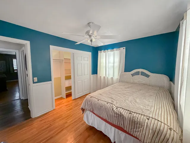 a spacious bedroom with a bed and window