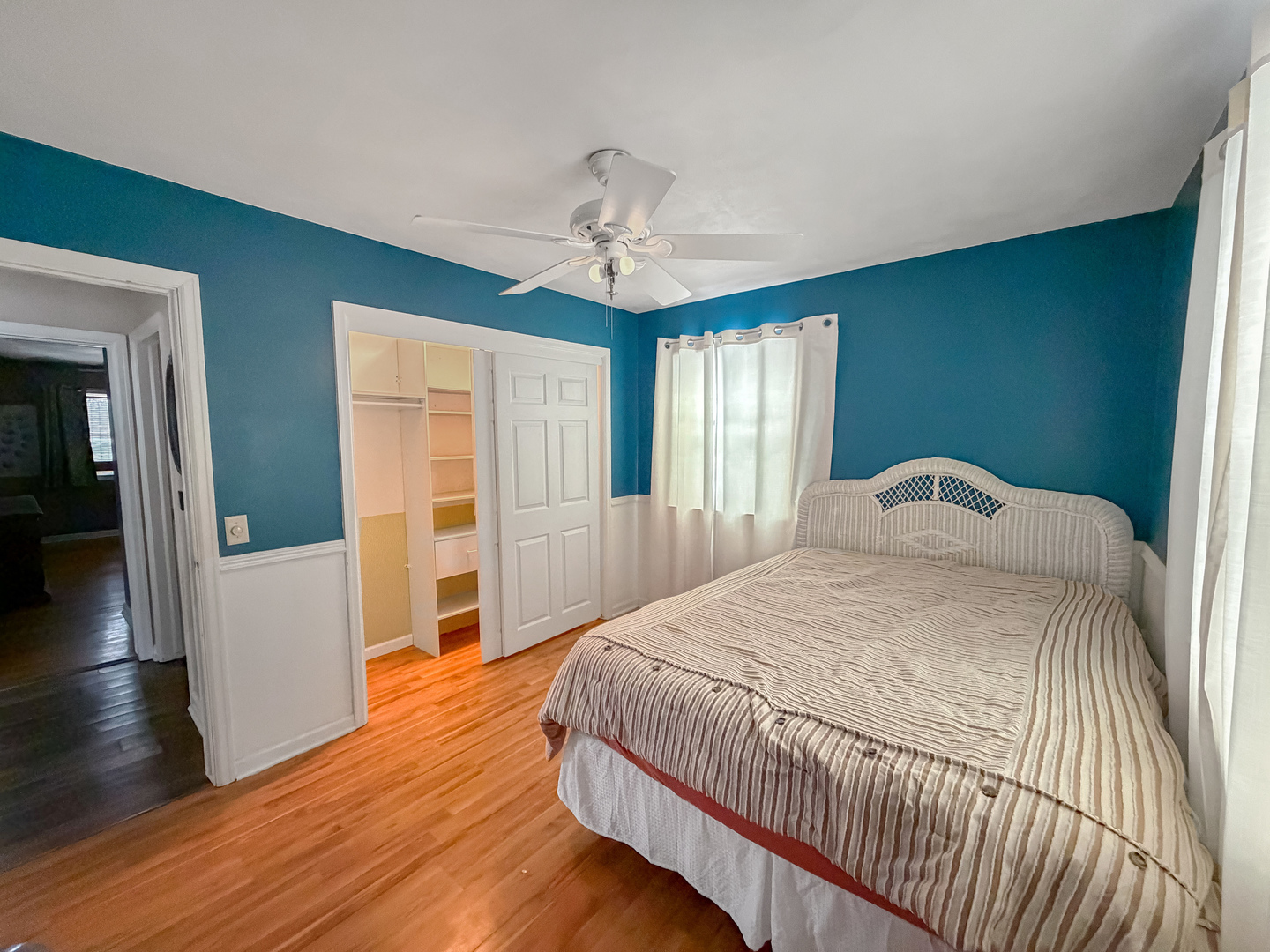1126 West Stover Street Freeport, IL 61032 - Photo 17 of 35 a spacious bedroom with a bed and a chandelier