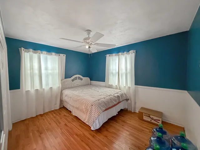 a bathroom with a sink a toilet a mirror a vanity a bathtub and shower