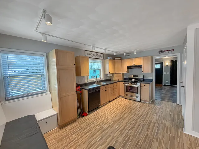 a bedroom with a bed and a view of kitchen