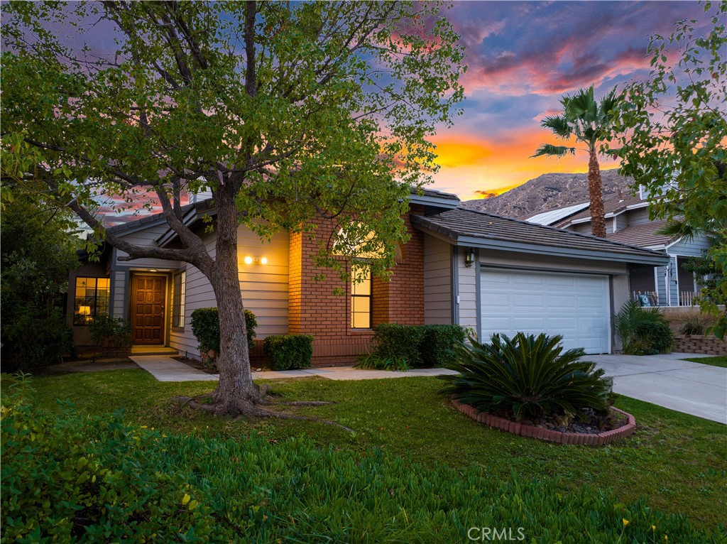 22571 Country Gate Road Moreno Valley, CA 92557 - Photo 1 of 1 a front view of a house with a garden and plants