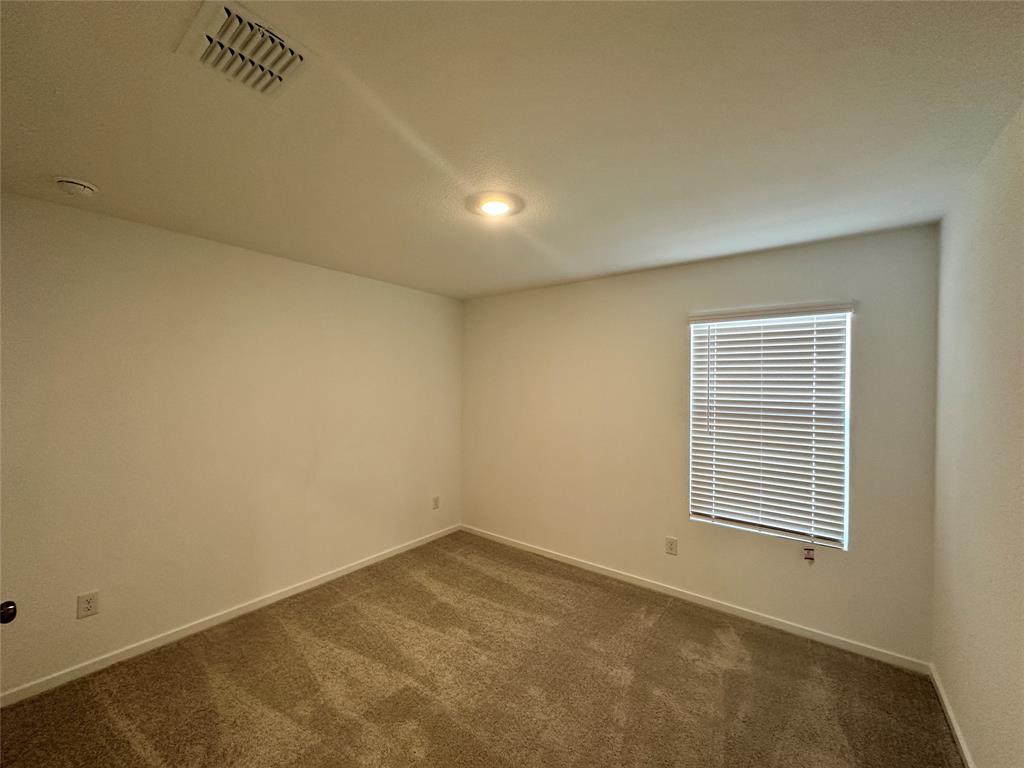 1034 Raintree Road Princeton, TX 75407 - Photo 10 of 17 an empty room with a window