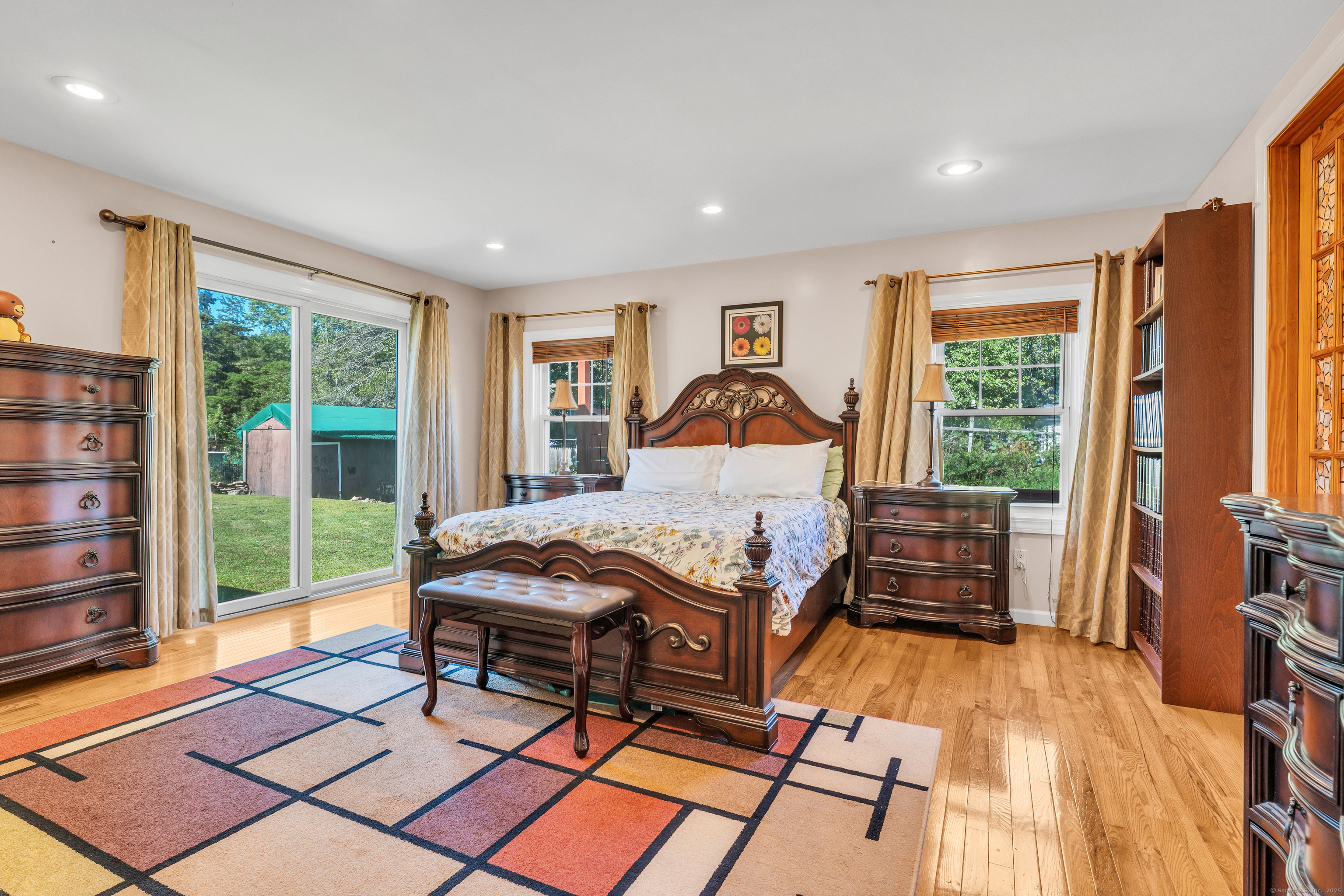 64 Dohm Avenue Guilford, CT 06437 - Photo 14 of 38 a living room with furniture a fireplace and large windows