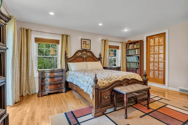 a living room with furniture a fireplace and large windows