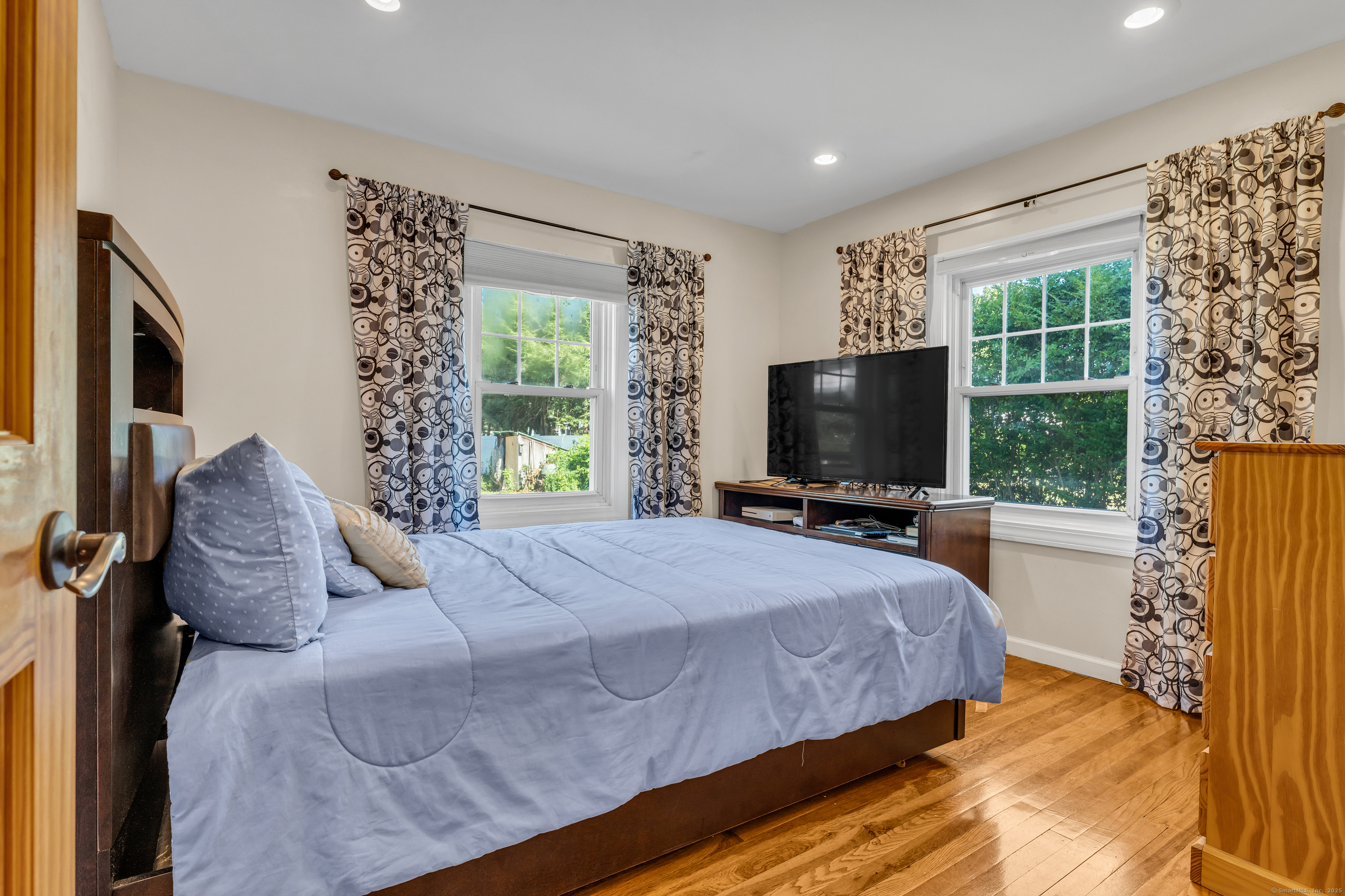 64 Dohm Avenue Guilford, CT 06437 - Photo 21 of 38 a bedroom with a large bed and a flat tv screen on dresser