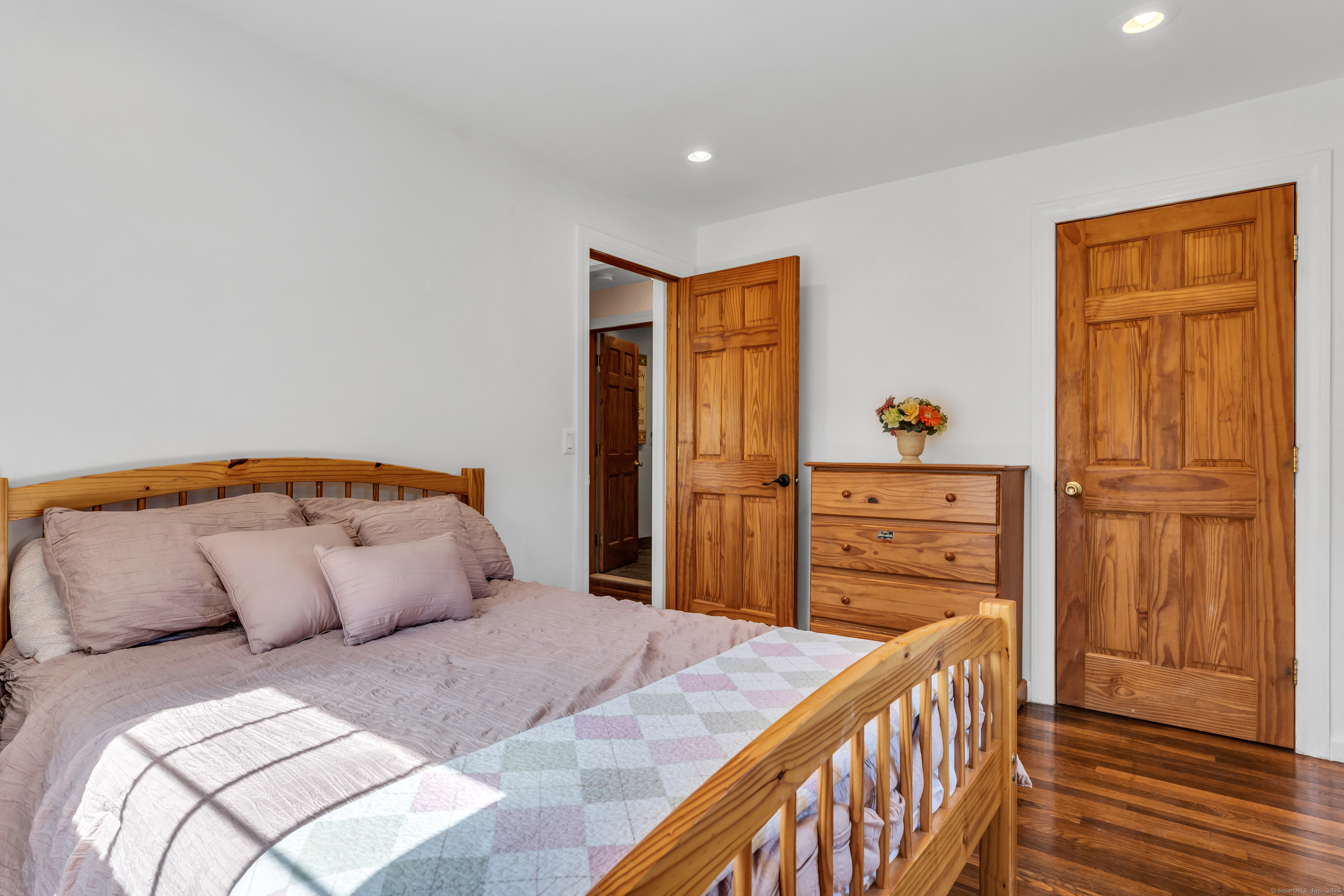 64 Dohm Avenue Guilford, CT 06437 - Photo 23 of 38 a bedroom with a bed and wooden floor