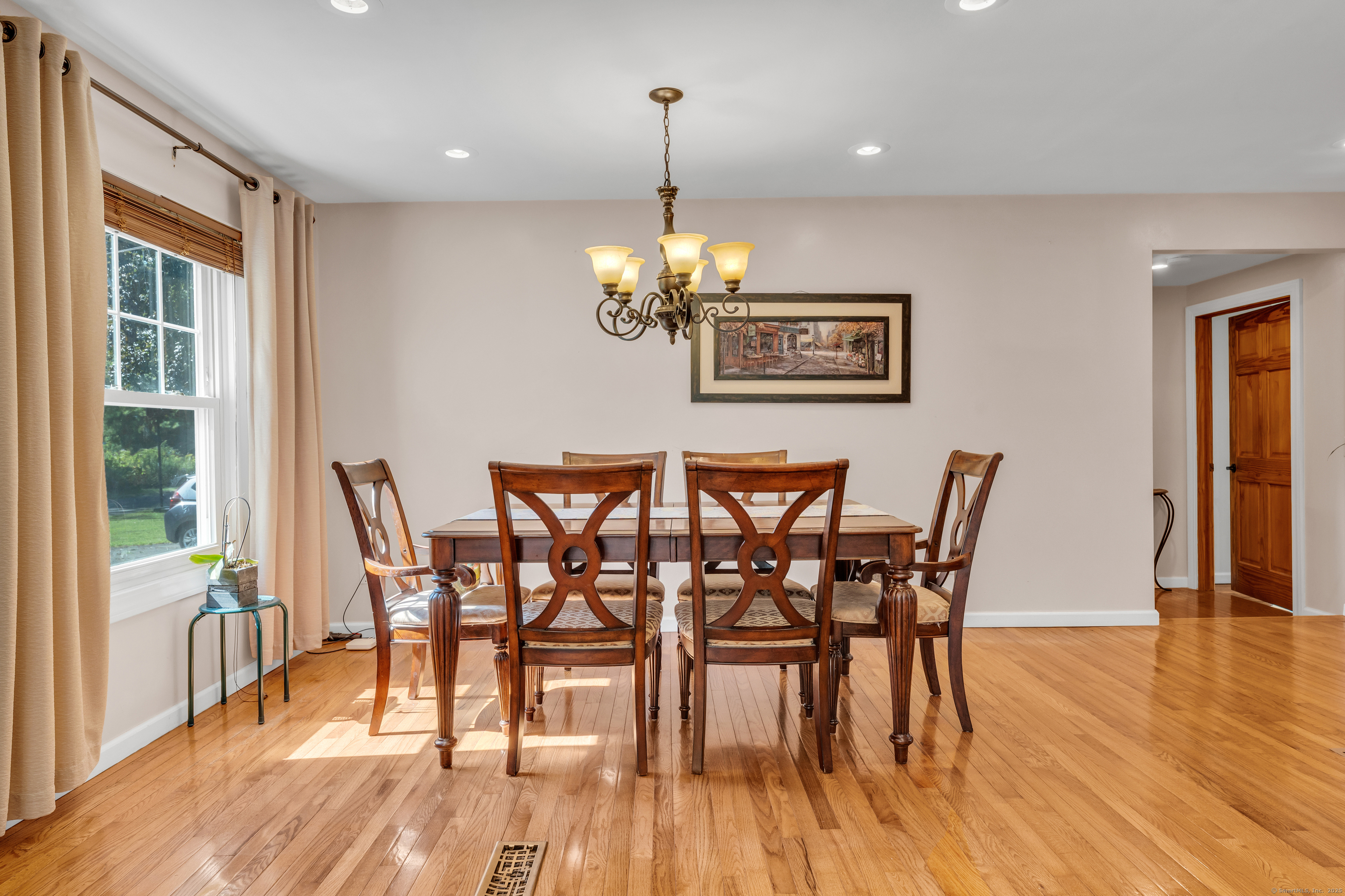 64 Dohm Avenue Guilford, CT 06437 - Photo 2 of 38 a dining room with furniture a chandelier and wooden floor