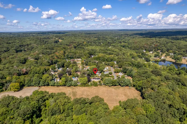 a view of a wooden fence and trees