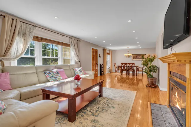 a living room with furniture flat screen tv and a fireplace