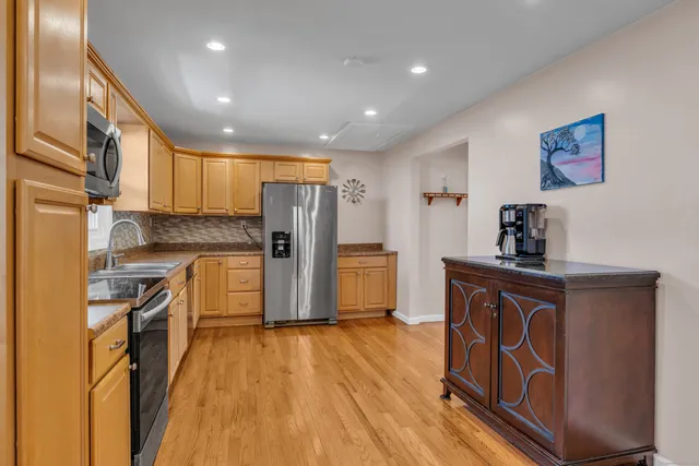 a kitchen with sink cabinets and wooden floor